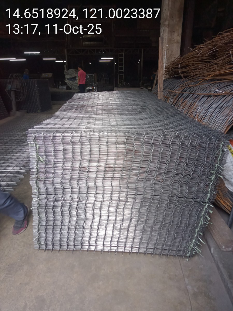 Galvanized steel matting sheets stacked in warehouse — Una Wire Products
